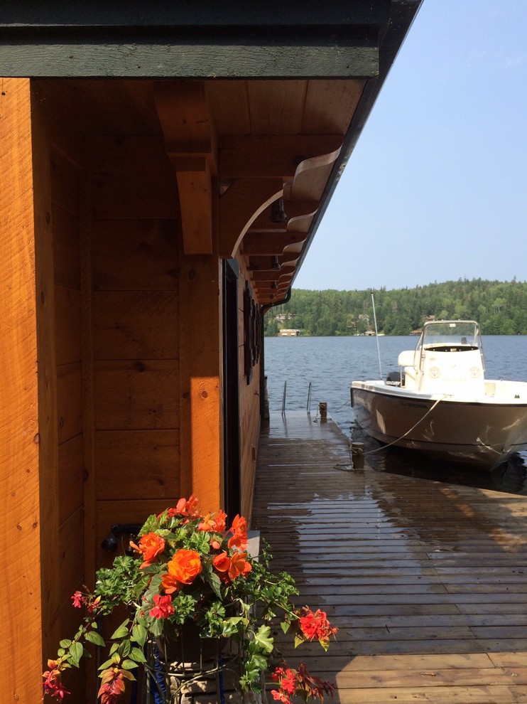 Large mountain style backyard dock photo with a pergola