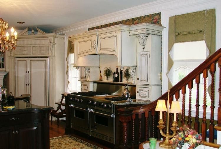 Ceramic tile open concept kitchen photo with raised-panel cabinets, white cabinets, granite countertops, beige backsplash and stainless steel appliances