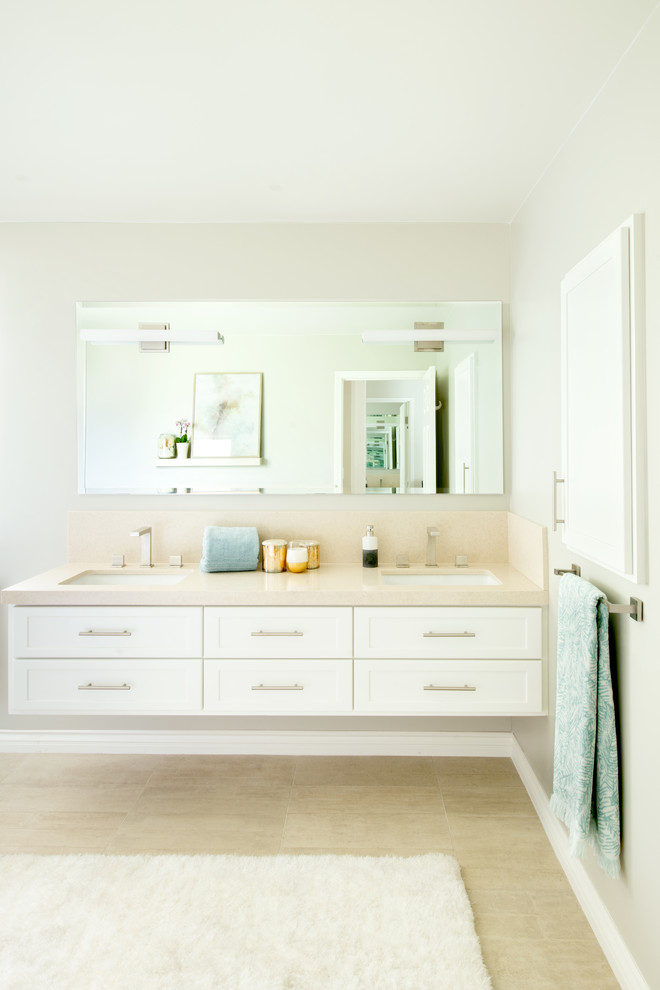 Photo of a mid-sized contemporary master bathroom in Los Angeles with shaker cabinets, white cabinets, a two-piece toilet, beige walls, beige floor and beige benchtops.
