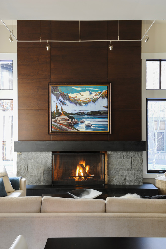 Design ideas for a large transitional open concept living room in Vancouver with white walls and a stone fireplace surround.