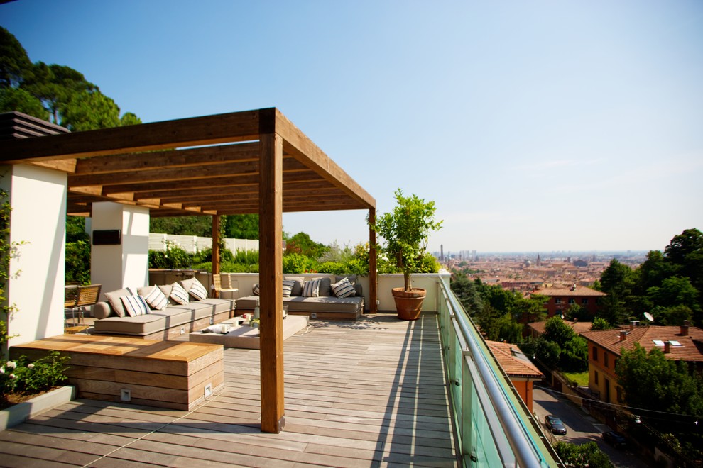 Photo of a mid-sized contemporary rooftop deck in Bologna with a pergola.