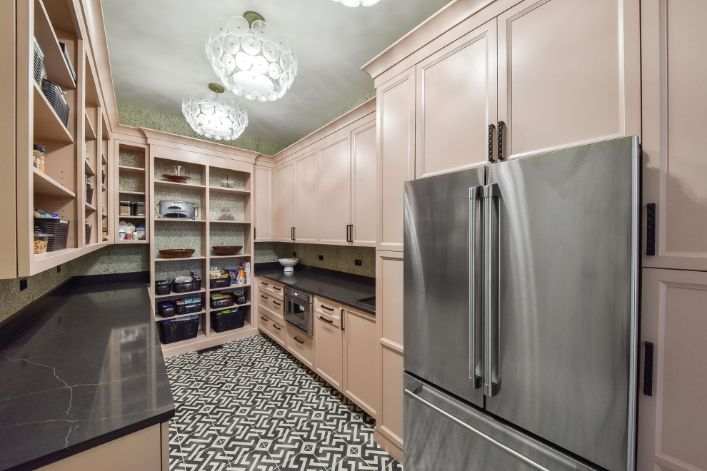 Large eclectic u-shaped kitchen pantry in Chicago with a single-bowl sink, flat-panel cabinets, pink cabinets, quartz benchtops, engineered quartz splashback, stainless steel appliances, cement tiles, black floor and white benchtop.