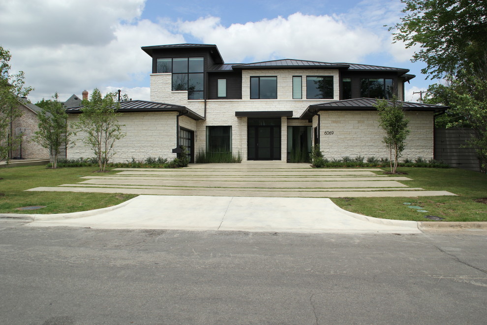 Design ideas for a mid-sized contemporary two-storey beige exterior in Dallas with stone veneer and a hip roof.