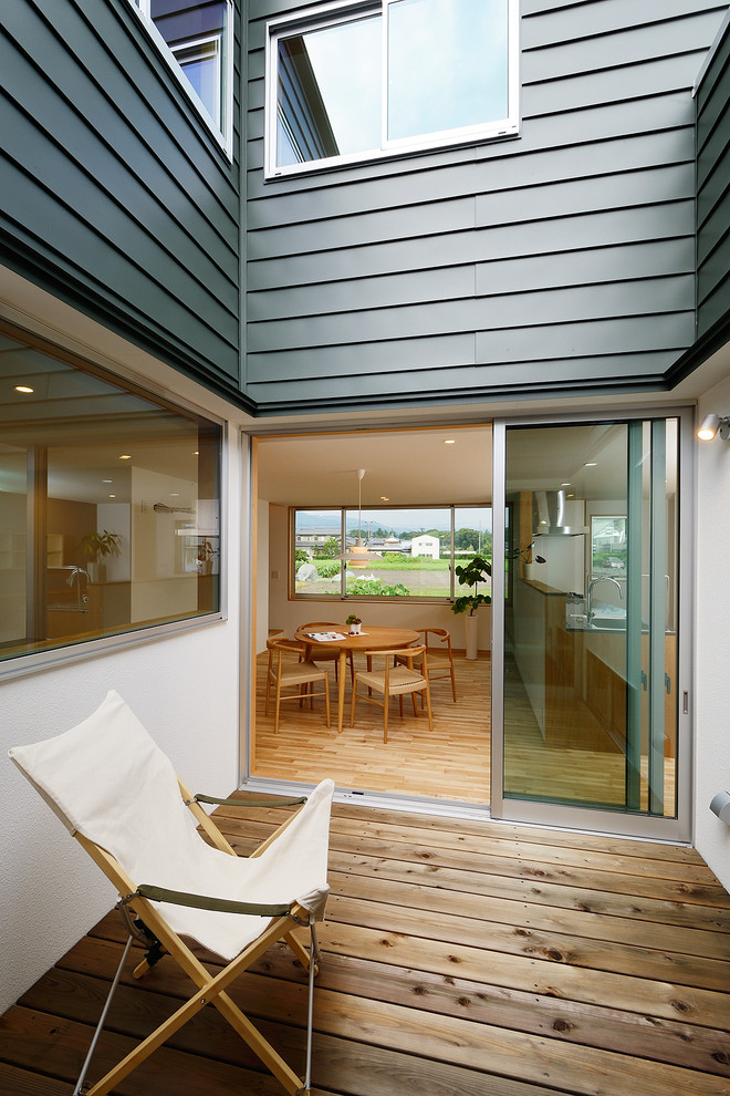 Photo of a mid-sized scandinavian courtyard patio in Other with decking.