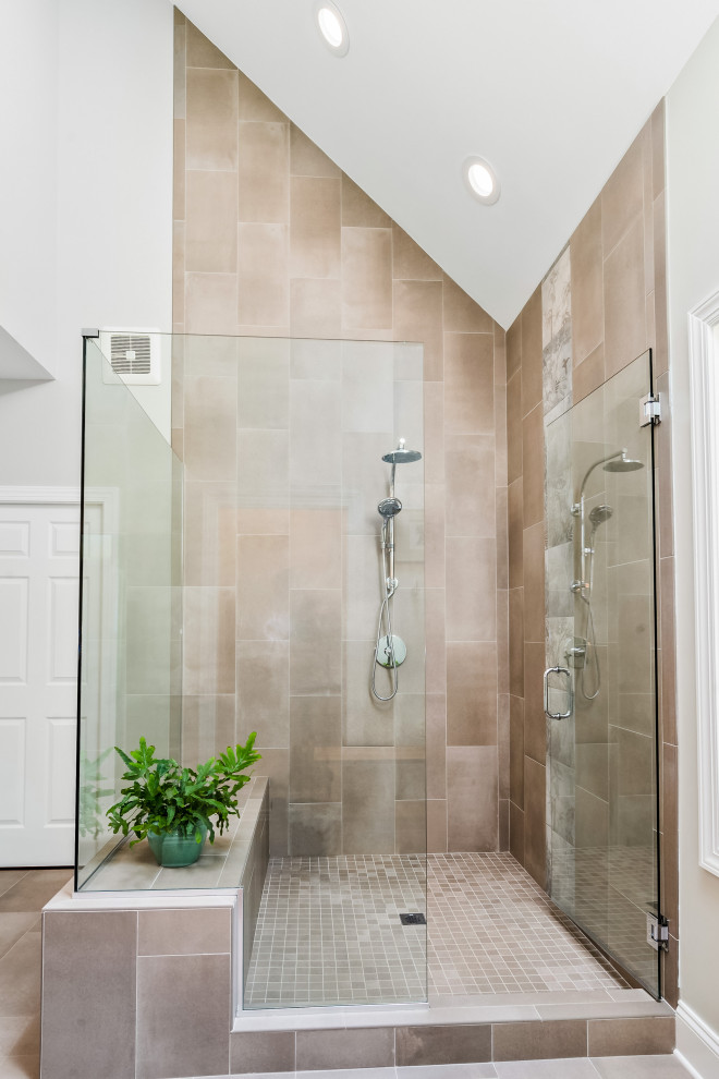 This is an example of a large transitional master bathroom in Raleigh with recessed-panel cabinets, white cabinets, a corner shower, gray tile, grey walls, porcelain floors, an undermount sink, granite benchtops, brown floor, a hinged shower door, grey benchtops, an enclosed toilet, a double vanity and a built-in vanity.