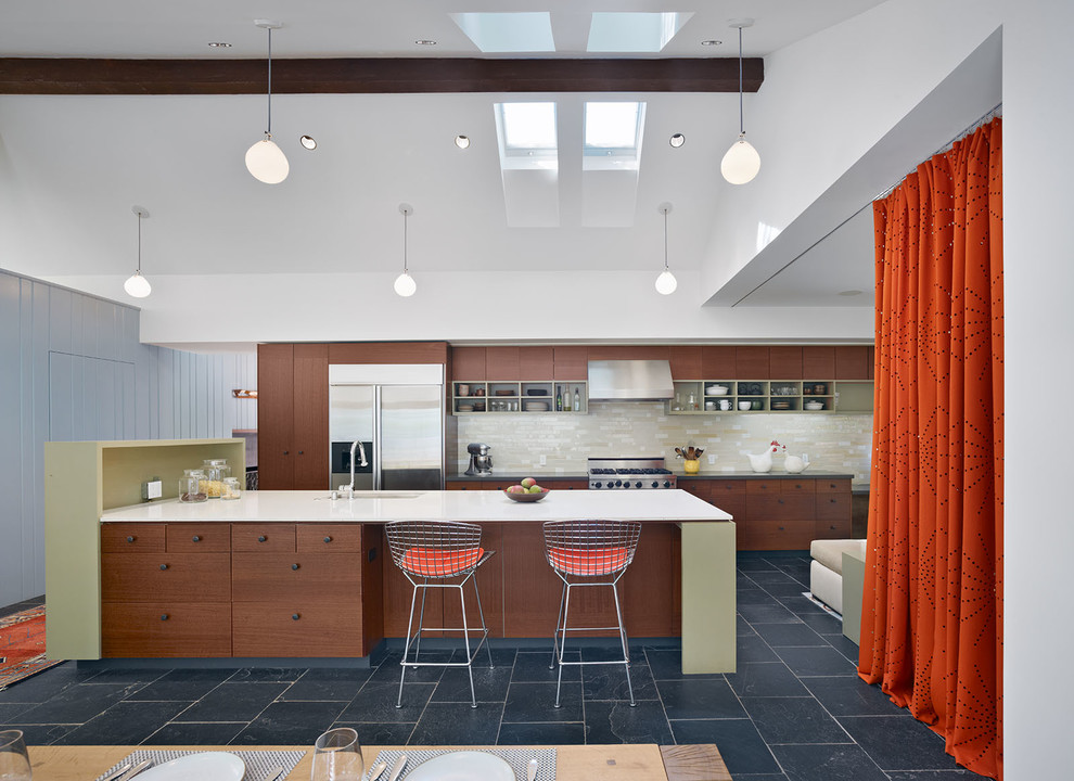 Contemporary galley eat-in kitchen in San Francisco with flat-panel cabinets, dark wood cabinets, stainless steel appliances, slate floors and with island.