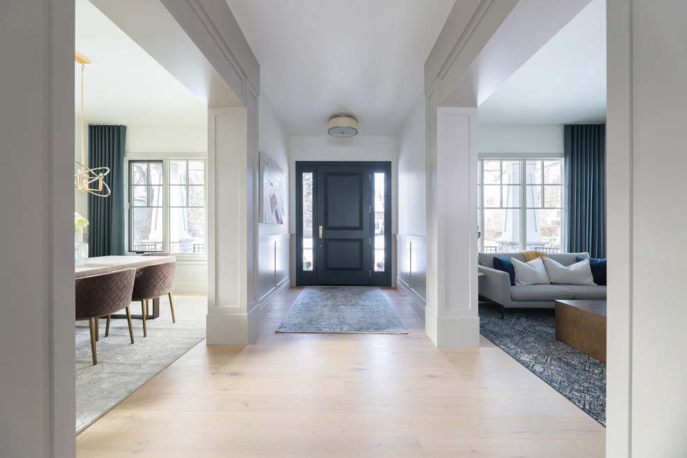 Inspiration for a large transitional light wood floor single front door remodel in Calgary with a blue front door