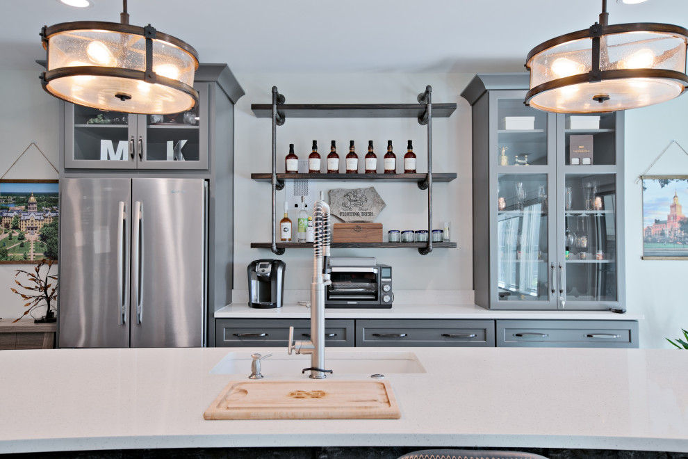 Large transitional galley medium tone wood floor and brown floor kitchen photo with an undermount sink, shaker cabinets, gray cabinets, quartzite countertops and white countertops