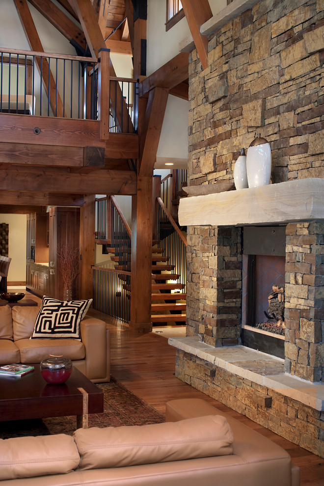 Traditional family room in Denver with a stone fireplace surround.