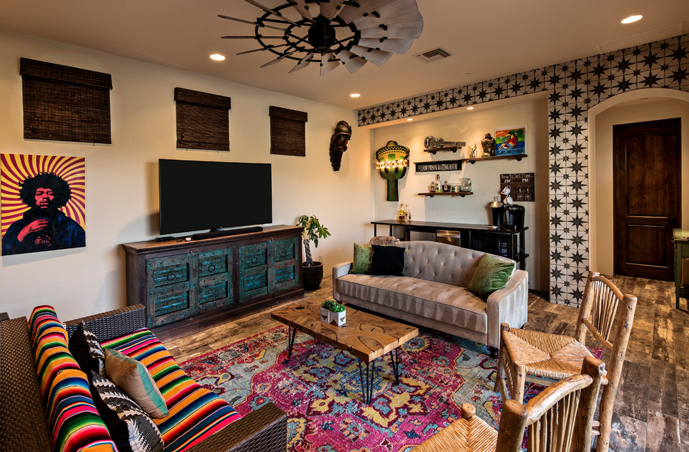 Design ideas for an eclectic open concept family room in Phoenix with a home bar, yellow walls, ceramic floors, no fireplace, a freestanding tv and grey floor.