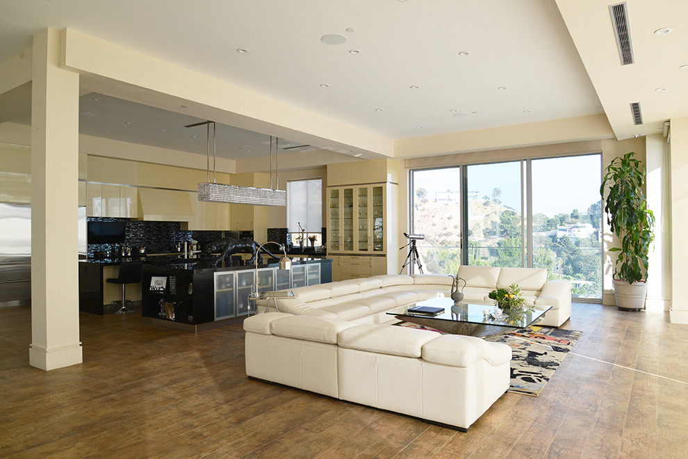 Inspiration for a large contemporary living room in Los Angeles with beige walls, ceramic floors and a wall-mounted tv.