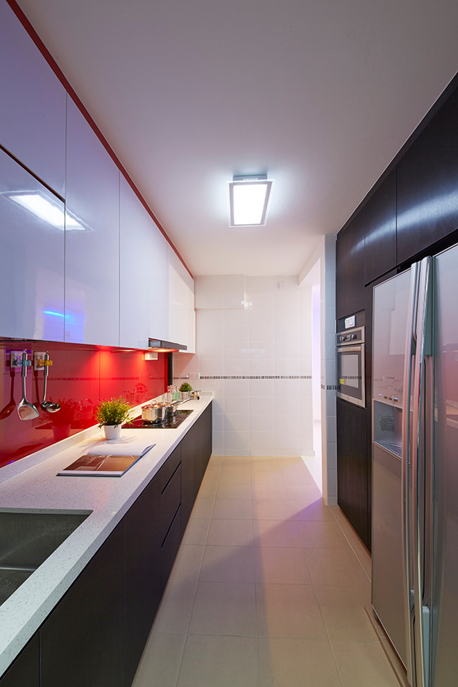 Photo of a small traditional galley kitchen pantry in Singapore with flat-panel cabinets, black cabinets, marble benchtops, red splashback, ceramic floors and with island.