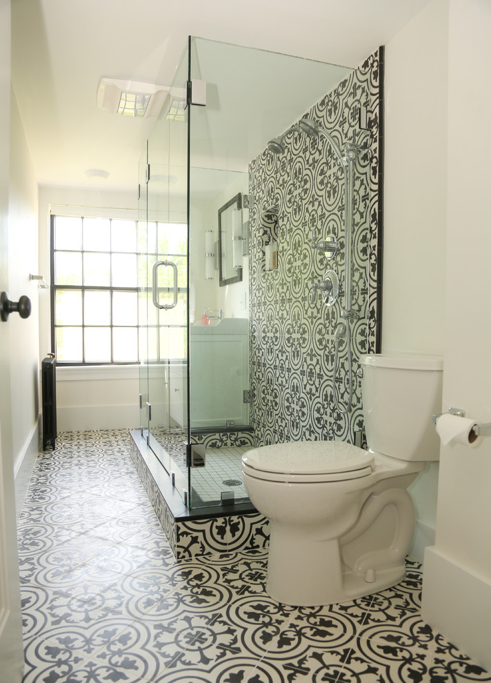 Photo of a transitional bathroom in Other with a curbless shower, black and white tile, cement tile, cement tiles, multi-coloured floor and a hinged shower door.