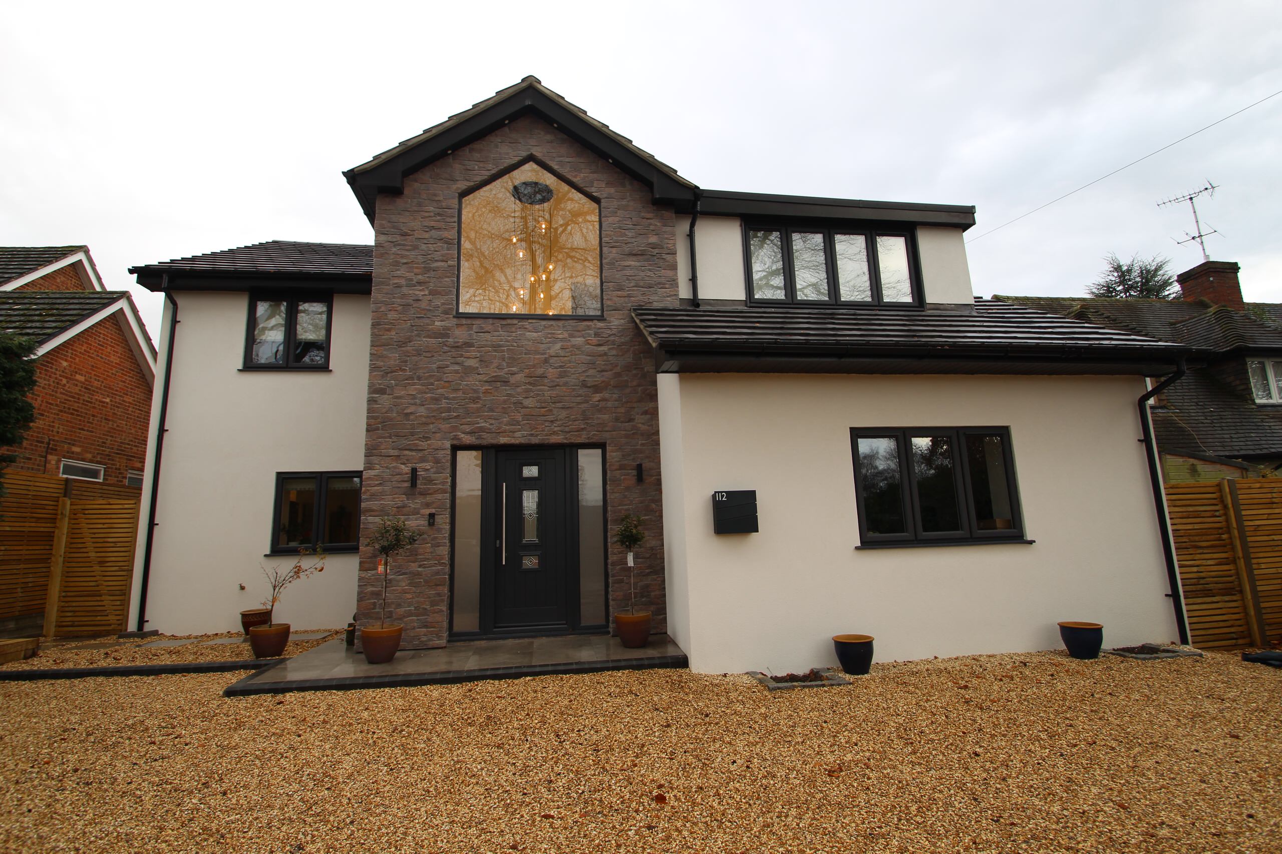 House exterior with shingled driveway