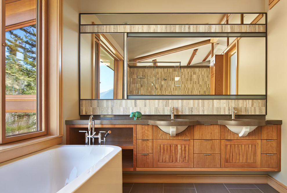 Mid-sized contemporary master bathroom in Seattle with an undermount sink, medium wood cabinets, engineered quartz benchtops, a freestanding tub, a curbless shower, stone tile, porcelain floors and flat-panel cabinets.