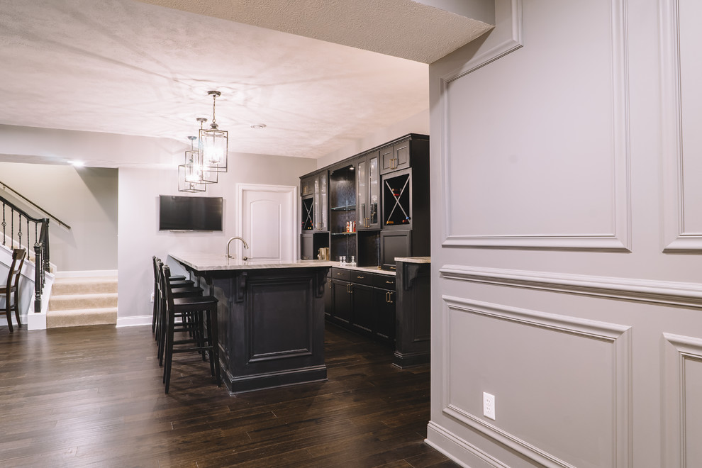 Seated home bar - large transitional galley dark wood floor seated home bar idea with an undermount sink, recessed-panel cabinets, marble countertops, black cabinets and mirror backsplash