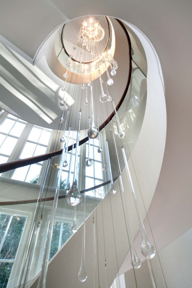 This is an example of a modern limestone spiral staircase in Other with limestone risers, wood railing and wallpaper.