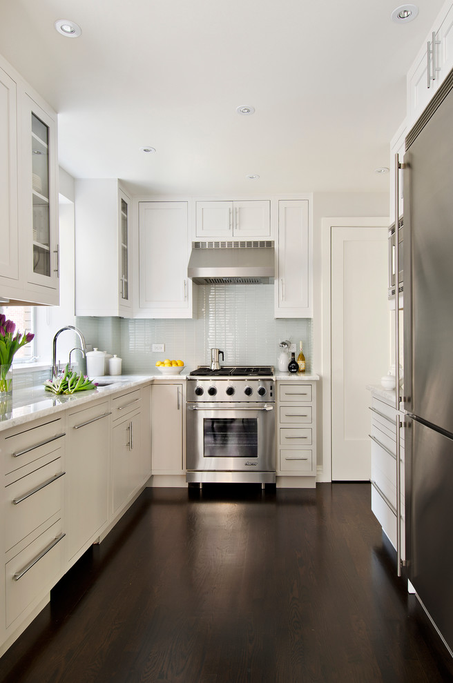Design ideas for a small traditional u-shaped kitchen in Miami with flat-panel cabinets, white cabinets, stainless steel appliances, dark hardwood floors, no island, quartzite benchtops, white splashback and an undermount sink.