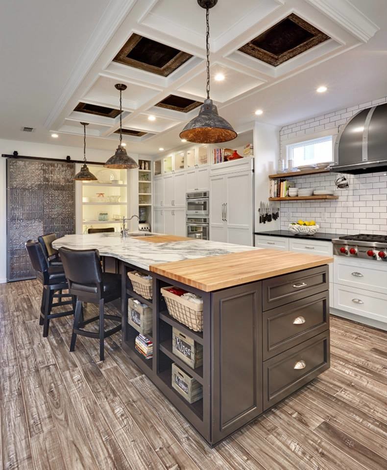 Large eclectic single-wall eat-in kitchen in Sacramento with a farmhouse sink, flat-panel cabinets, white cabinets, marble benchtops, white splashback, subway tile splashback, stainless steel appliances, porcelain floors and with island.