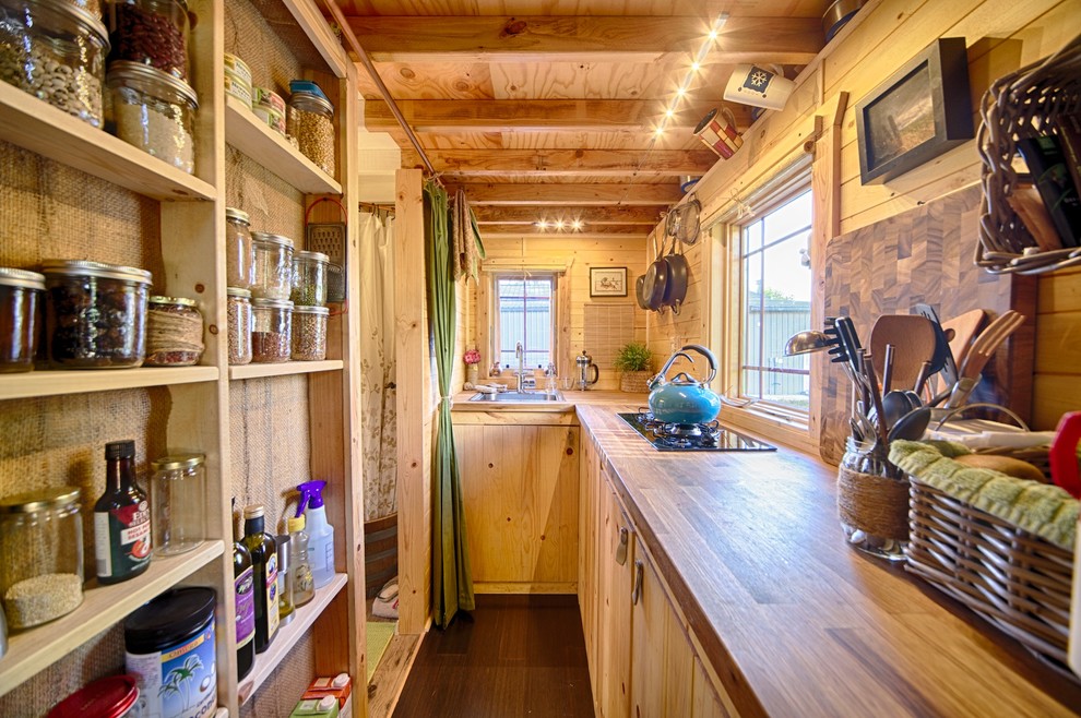 Inspiration for a country separate kitchen in Seattle with a drop-in sink, flat-panel cabinets, light wood cabinets and wood benchtops.