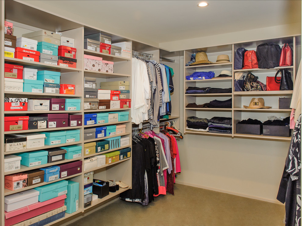 Inspiration for a large modern women's dressing room in Sydney with open cabinets, beige cabinets and carpet.