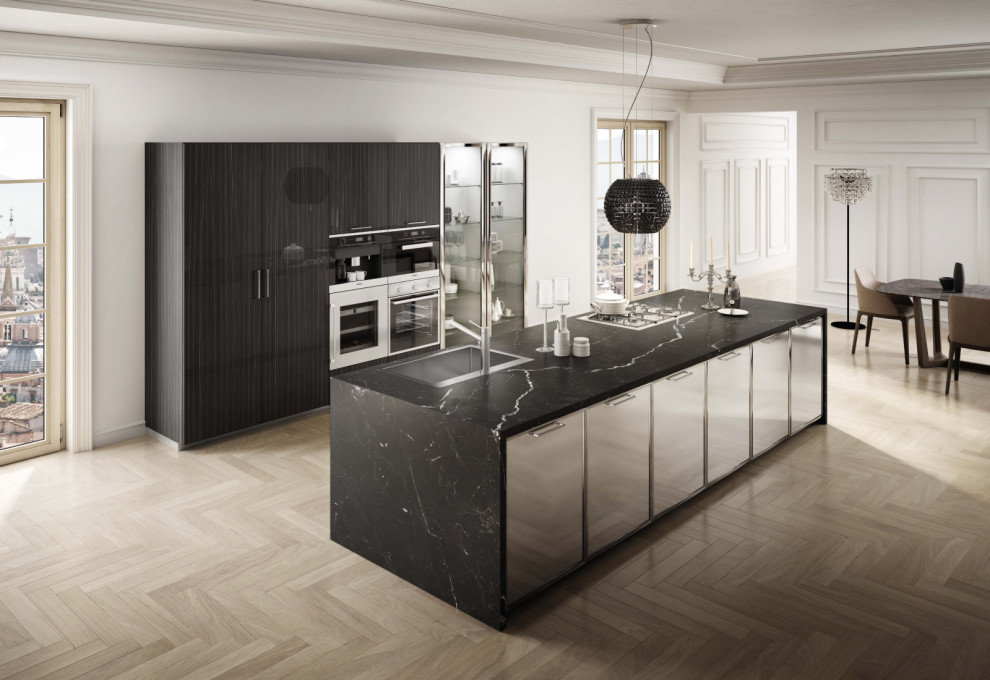 Photo of a large modern kitchen in Miami with flat-panel cabinets, stainless steel cabinets, marble worktops, stainless steel appliances and black worktops.