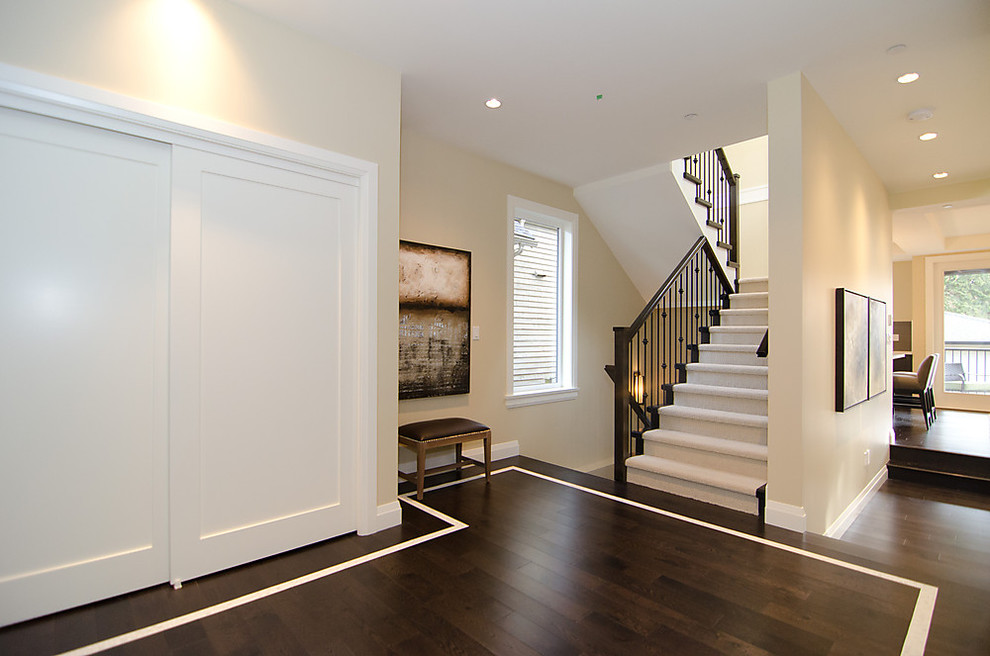 Inspiration for a traditional hallway in Vancouver with beige walls, dark hardwood floors and brown floor.