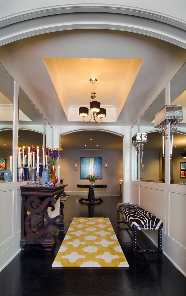 This is an example of a contemporary hallway in Houston with white walls and black floor.