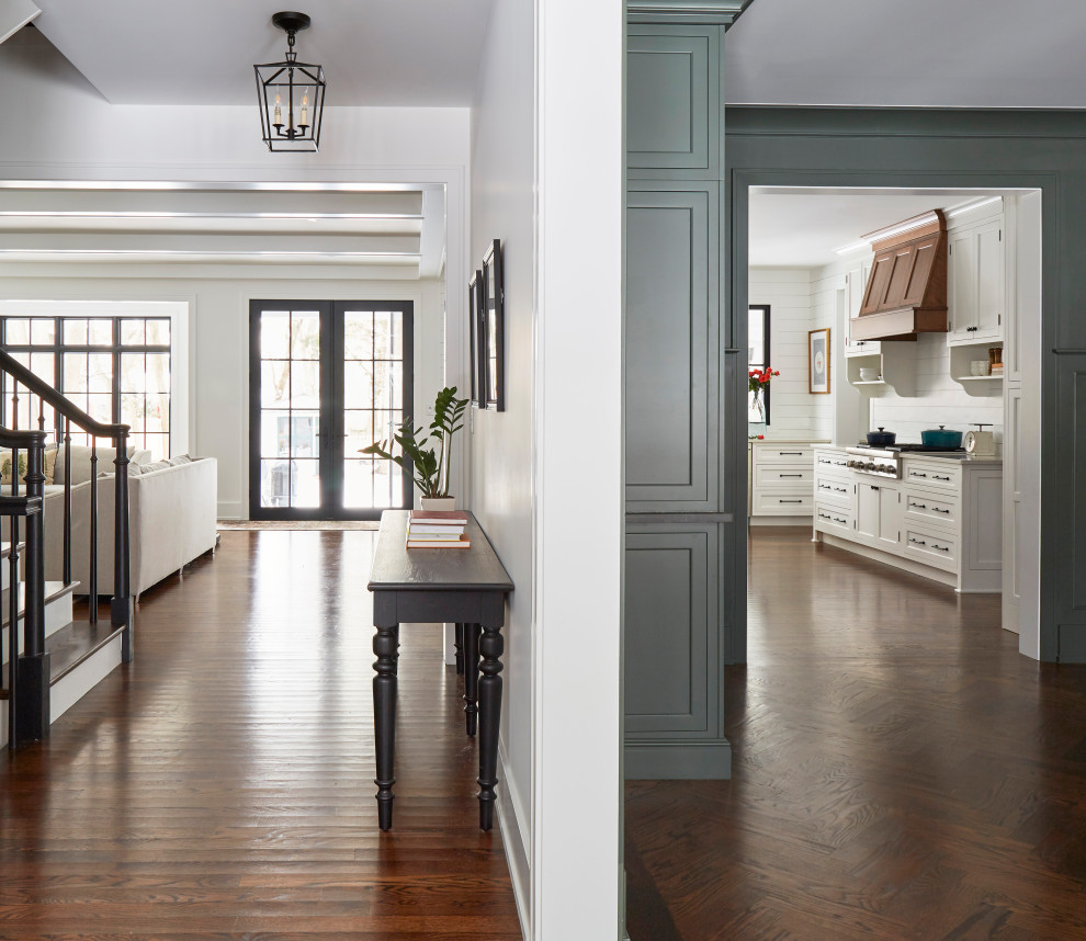 Inspiration for a large country medium tone wood floor and brown floor foyer remodel in Chicago with white walls