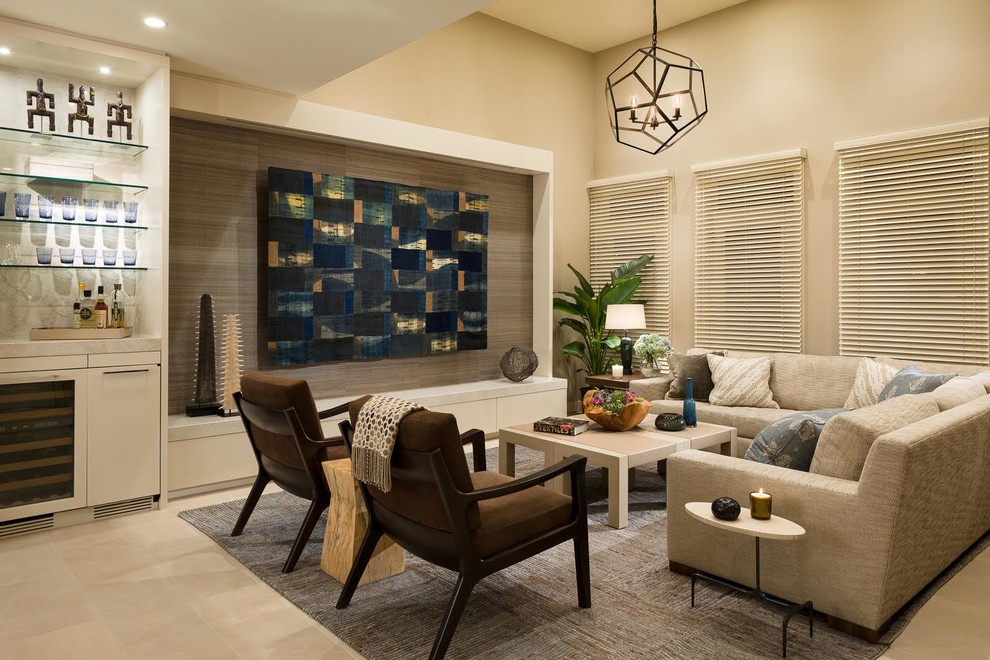 Mid-sized contemporary open concept family room in Orange County with beige walls, limestone floors, no fireplace, beige floor and a concealed tv.