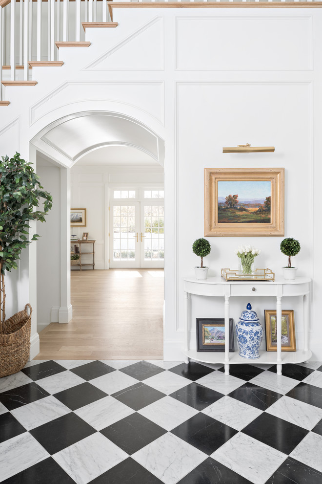 Inspiration for a traditional foyer in Salt Lake City with white walls and black floor.
