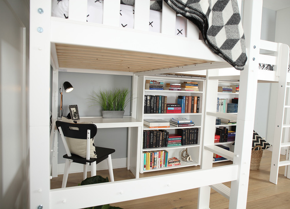 This is an example of a small modern gender neutral teen’s room in Other with grey walls and light hardwood flooring.