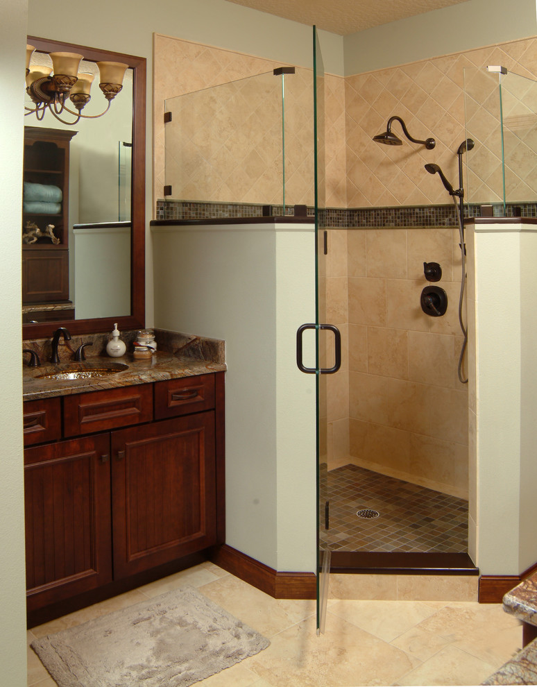 This is an example of a transitional master bathroom in Orlando with beaded inset cabinets.