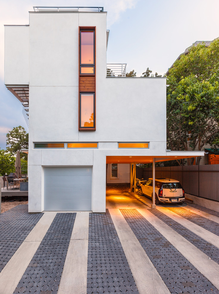 This is an example of a large contemporary attached two-car garage in Austin.
