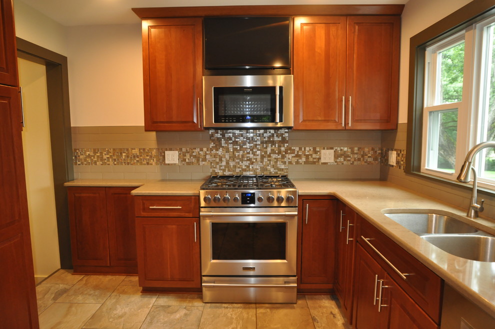 Kitchen photo in Chicago with stainless steel appliances and beige countertops