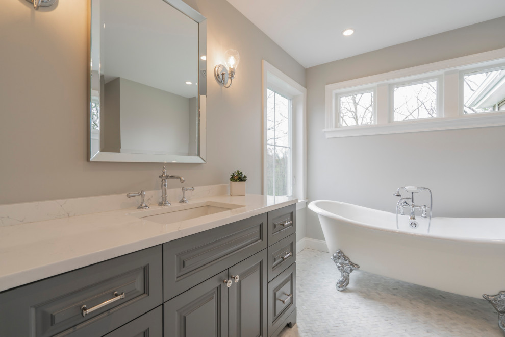 Photo of a large master bathroom in Philadelphia with raised-panel cabinets, grey cabinets, a claw-foot tub, an alcove shower, a two-piece toilet, grey walls, marble floors, an undermount sink, engineered quartz benchtops, white floor, a hinged shower door, white benchtops, a single vanity and a freestanding vanity.