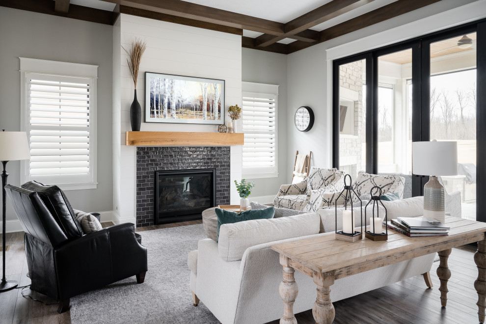 Photo of a medium sized traditional formal open plan living room in Indianapolis with white walls, medium hardwood flooring, a standard fireplace, a metal fireplace surround and no tv.