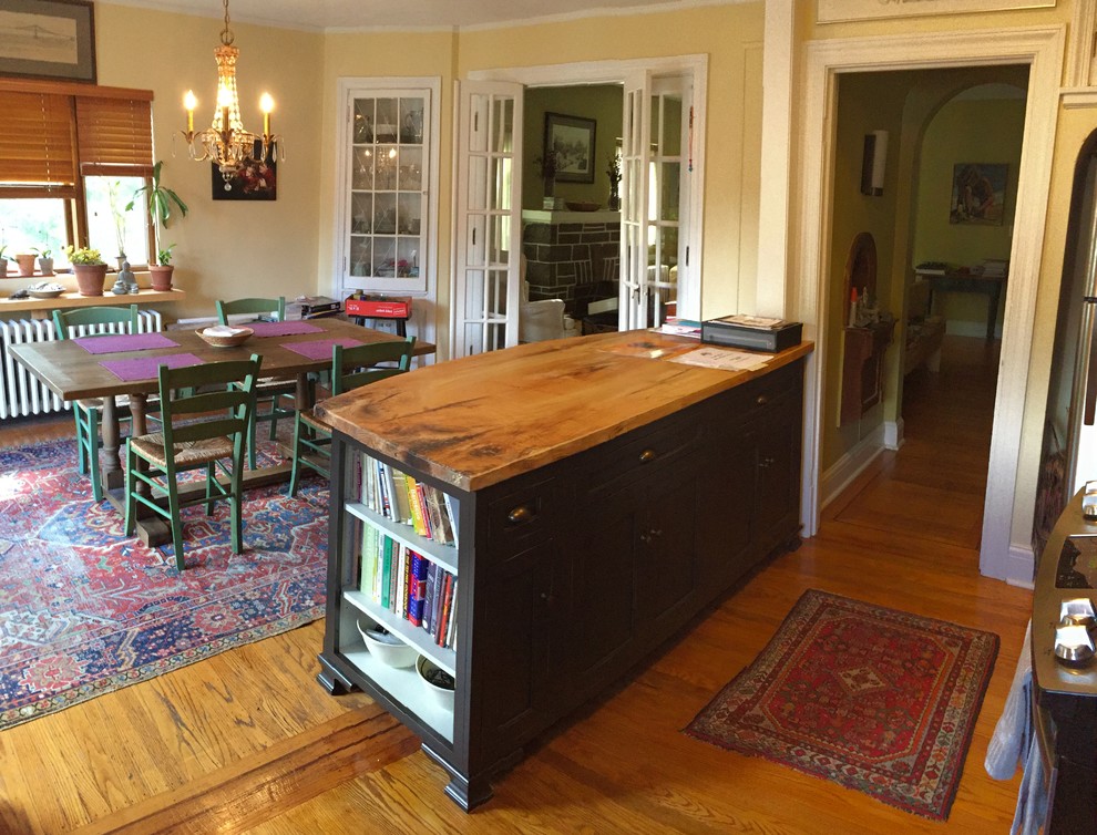 Inspiration for a mid-sized transitional galley light wood floor eat-in kitchen remodel in Baltimore with flat-panel cabinets, brown cabinets, wood countertops and an island