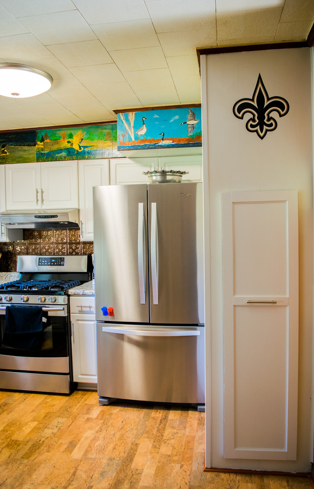 Mid-sized traditional u-shaped separate kitchen in New Orleans with a drop-in sink, raised-panel cabinets, white cabinets, granite benchtops, brown splashback, metal splashback, stainless steel appliances, no island and brown floor.