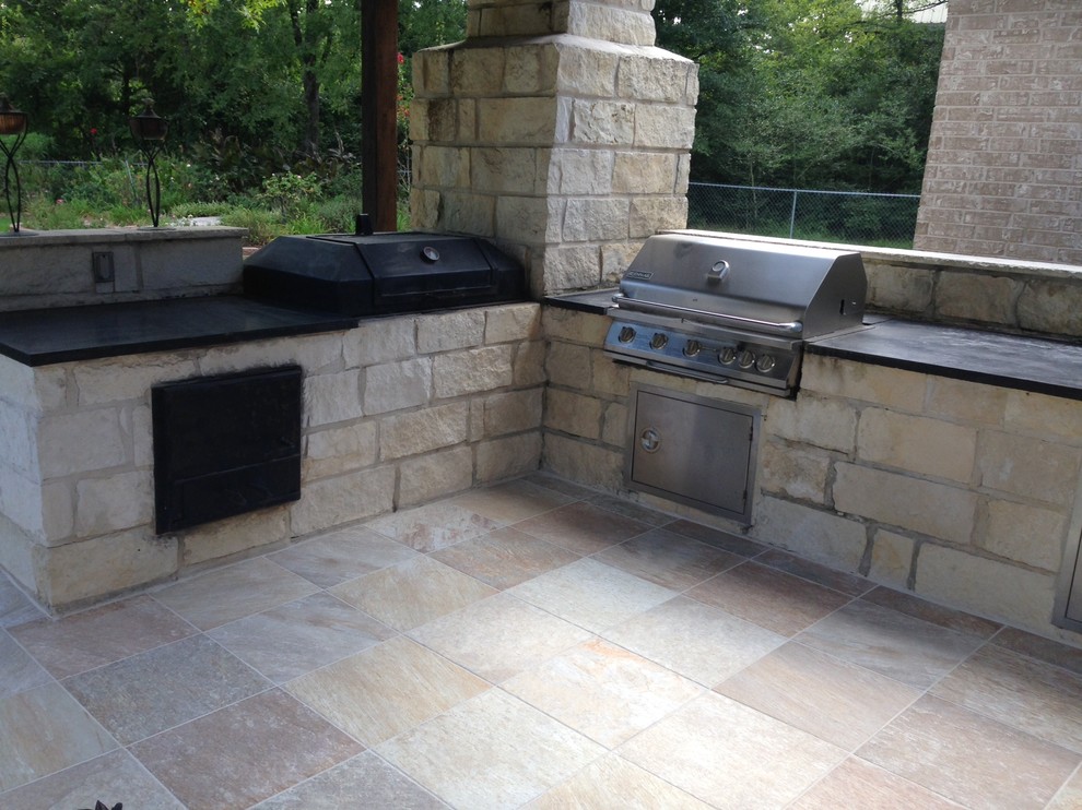 Inspiration for a mid-sized country backyard patio in Austin with tile, an outdoor kitchen and a pergola.