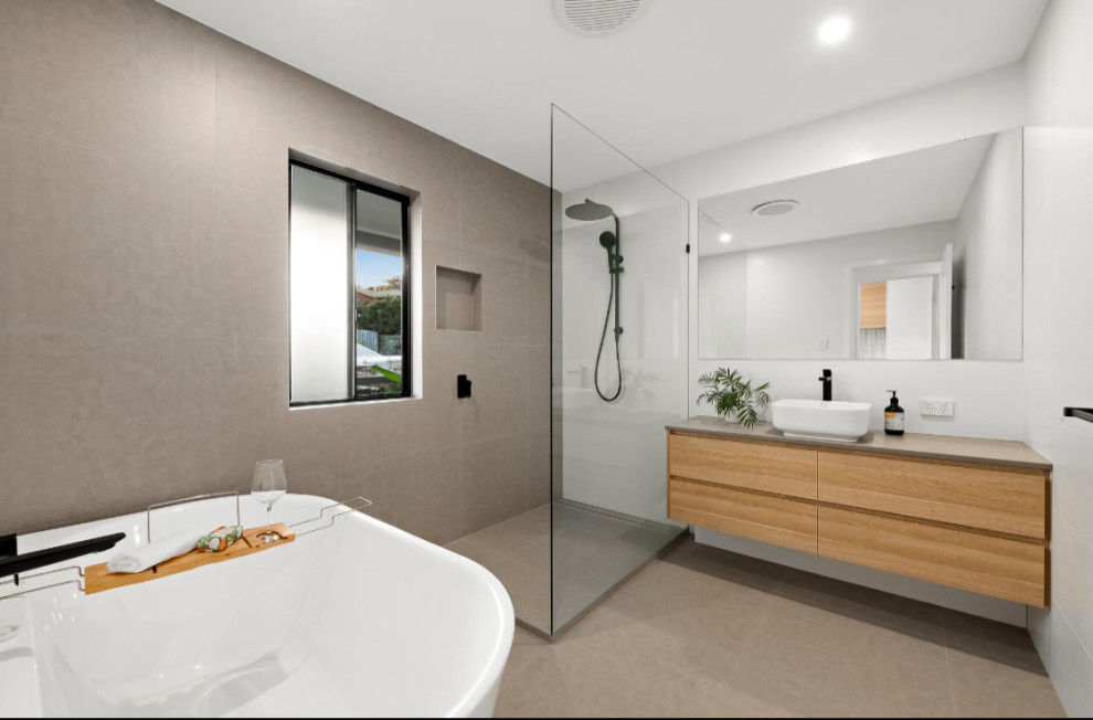 Large modern 3/4 wet room bathroom in Sunshine Coast with flat-panel cabinets, light wood cabinets, white tile, white walls, engineered quartz benchtops, beige floor, an open shower, beige benchtops, a single vanity and a floating vanity.