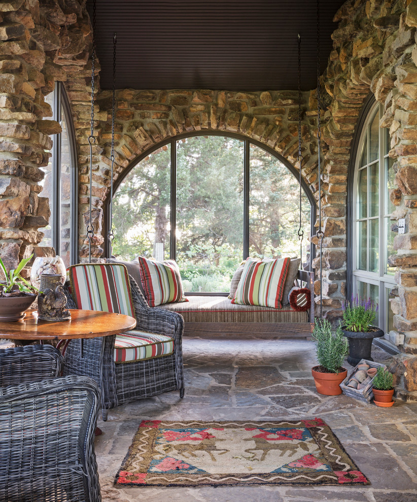 This is an example of a country sunroom in Other with no fireplace.