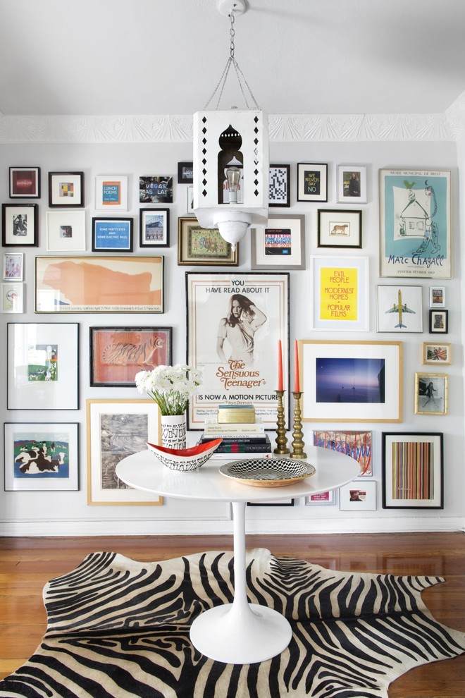 Inspiration for an eclectic foyer in Los Angeles with white walls and medium hardwood floors.