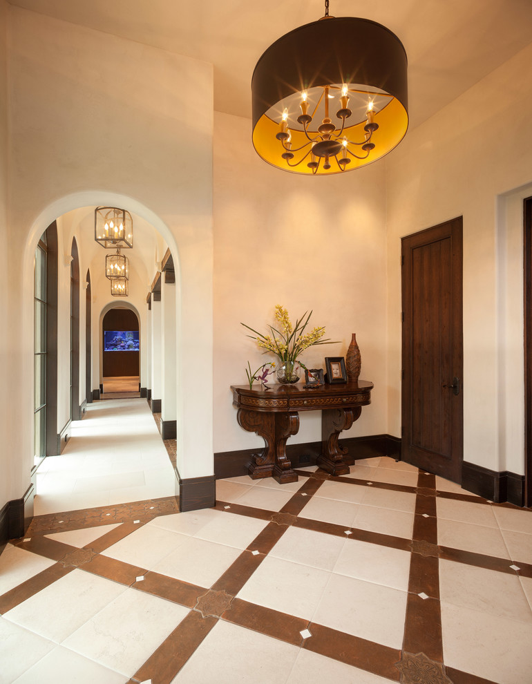 Design ideas for a mid-sized mediterranean foyer in Houston with beige walls, ceramic floors, a single front door, a dark wood front door and multi-coloured floor.