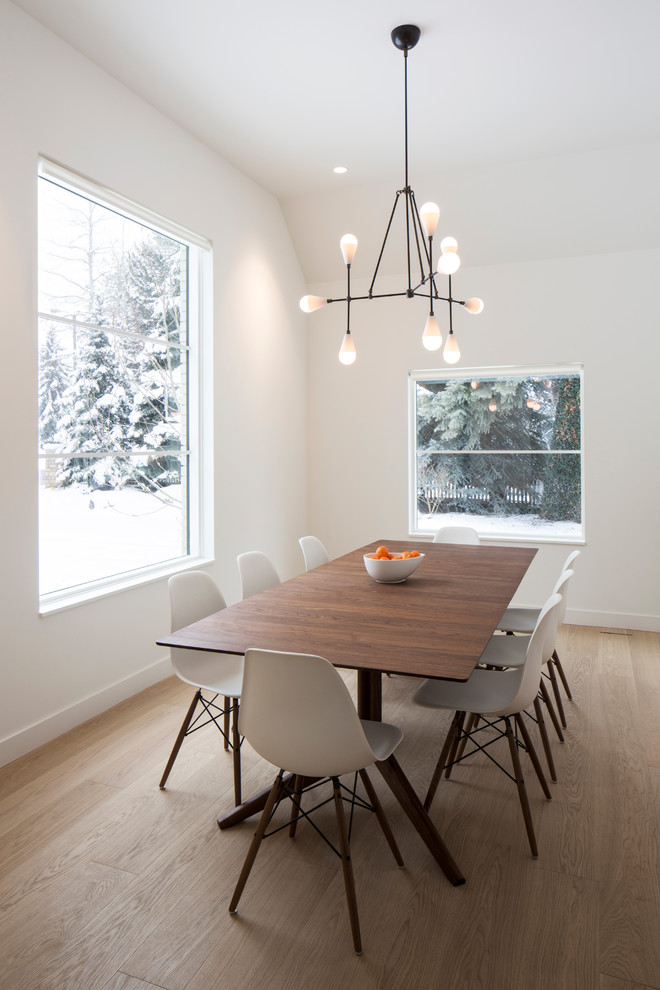Scandinavian dining room in Salt Lake City with white walls and light hardwood floors.