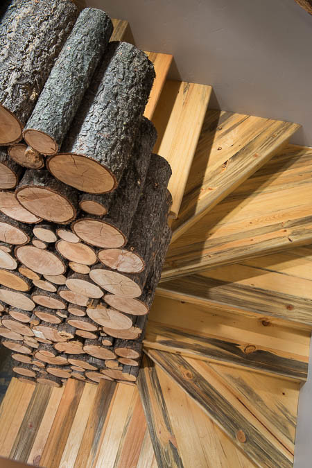Inspiration for a small rustic wooden curved wood railing staircase remodel with wooden risers