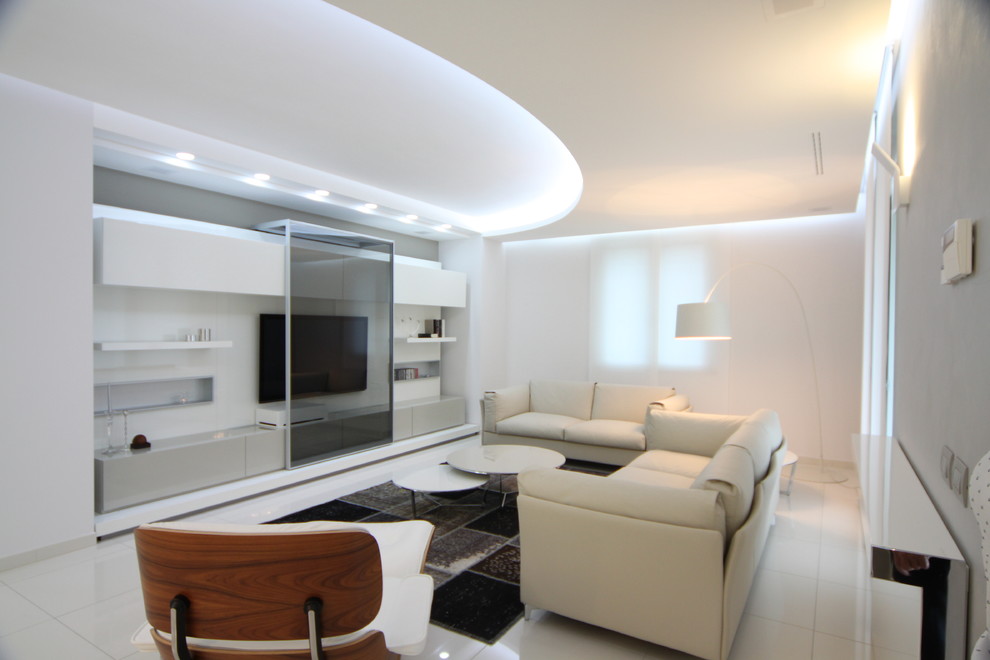 Mid-sized contemporary enclosed family room in Milan with white walls and a wall-mounted tv.