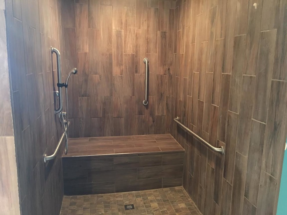 Inspiration for a transitional brown tile and porcelain tile alcove shower remodel