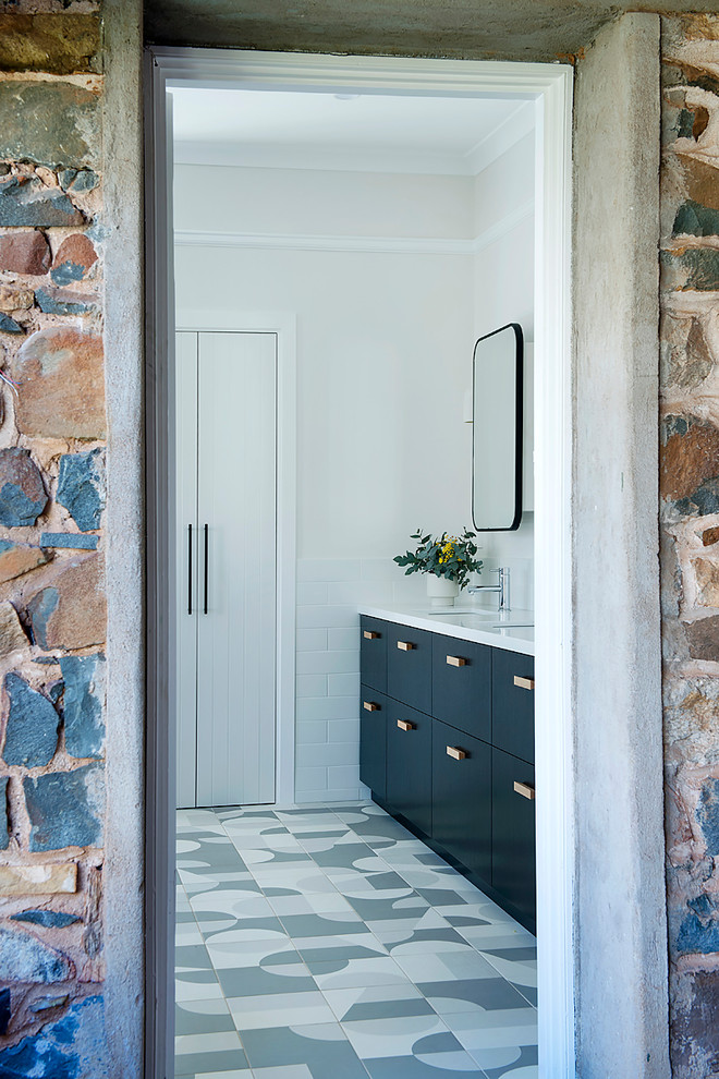 Photo of a large contemporary kids bathroom in Perth with black cabinets, a drop-in tub, white tile, ceramic tile, engineered quartz benchtops, an open shower, white walls, ceramic floors, an undermount sink and an open shower.