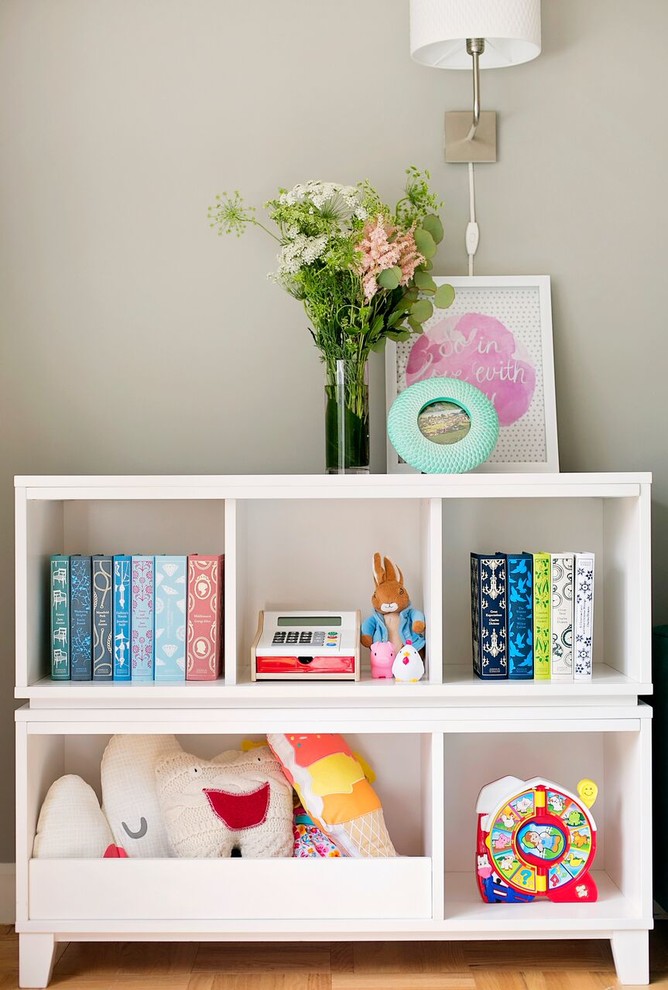 Design ideas for a mid-sized transitional nursery for girls in New York with grey walls and carpet.